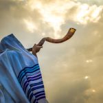 Jewish Man In A Tallith Prayer Shawl Against Dramatic Sky